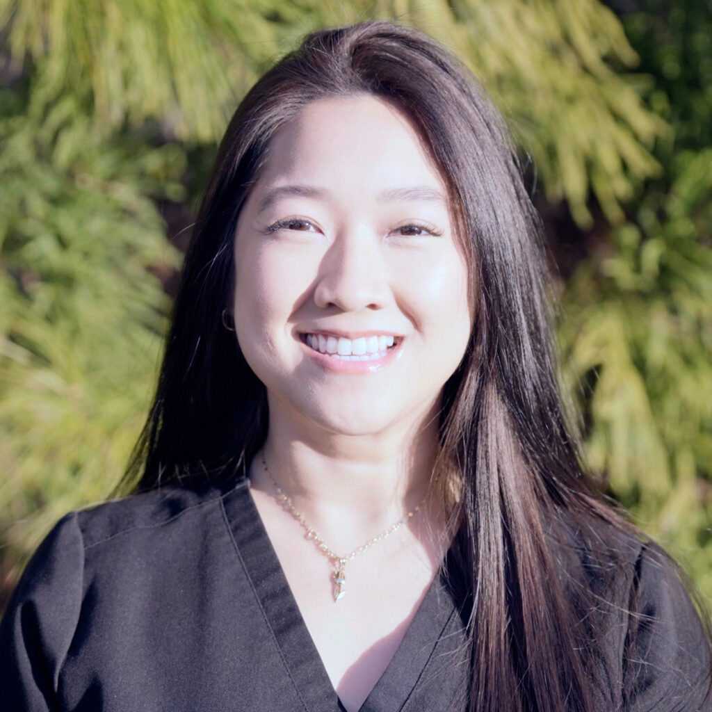 Portrait of Trina Tran, a smiling dental assistant wearing black scrubs at Premier Prosthodontics.